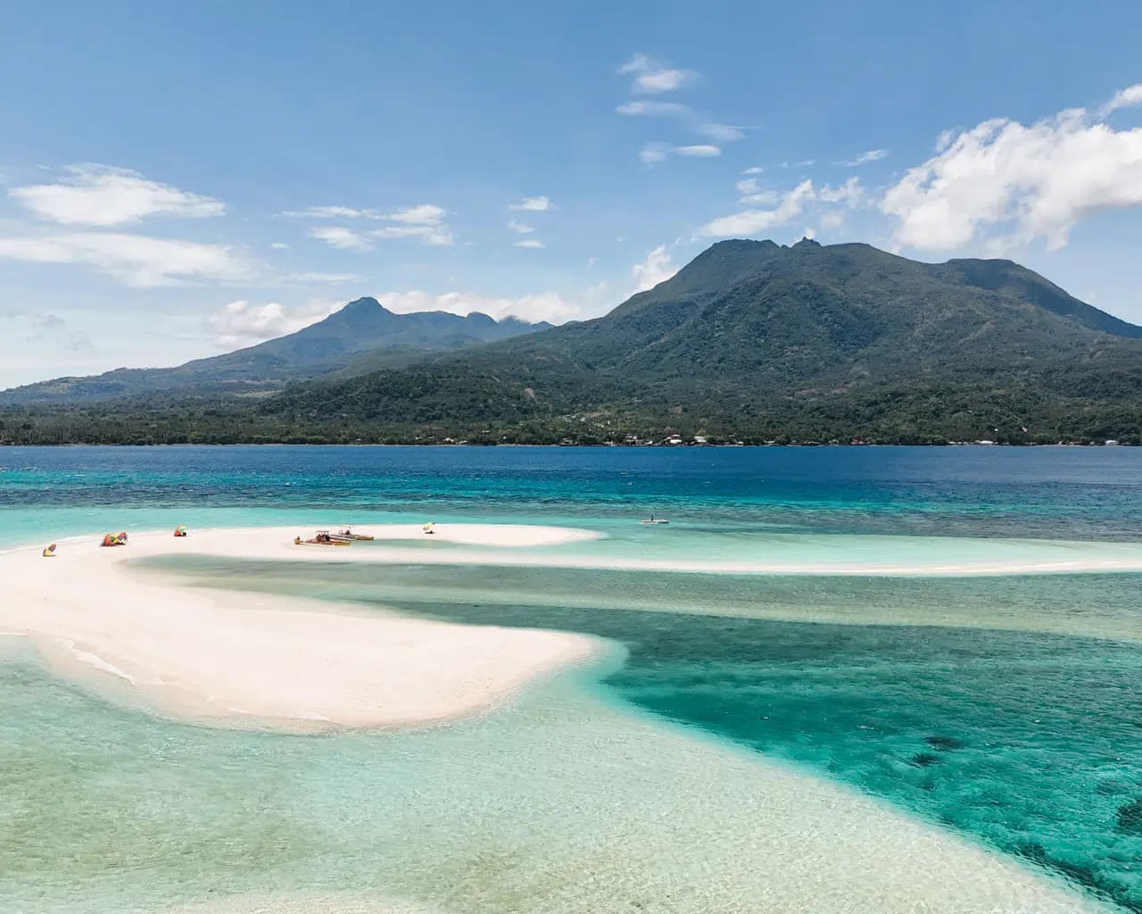 The White Island sandbar with bancas moored off Camiguin and the volcanoes behind — the reward at the end of a Philippine island chain
