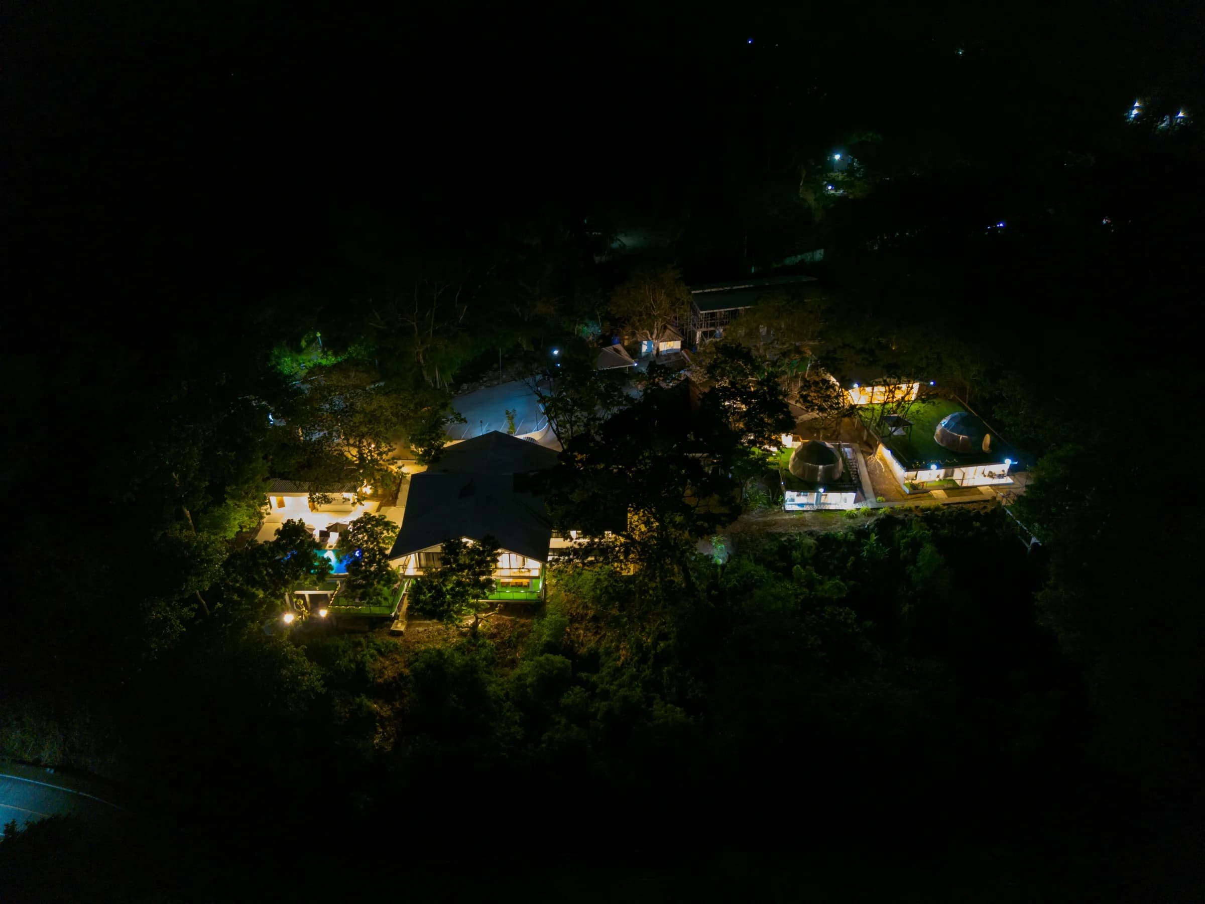 Camiguin's dark, unlit coast at night from the air — the quiet counterpart to Bohol's developed resort strips