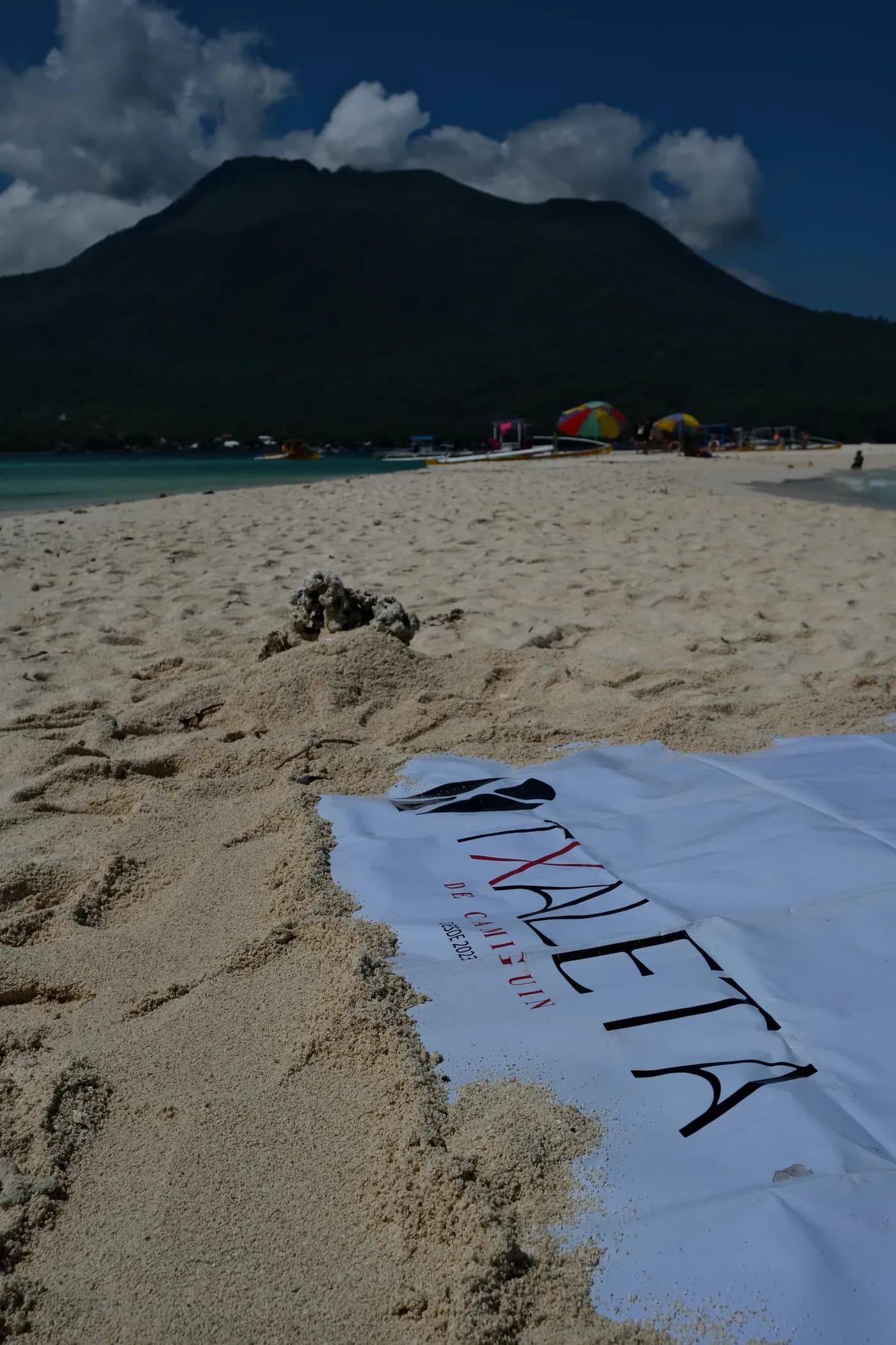 A table set outdoors on the Txaleta clifftop above the Bohol Sea, the small practical comforts of a day on Camiguin